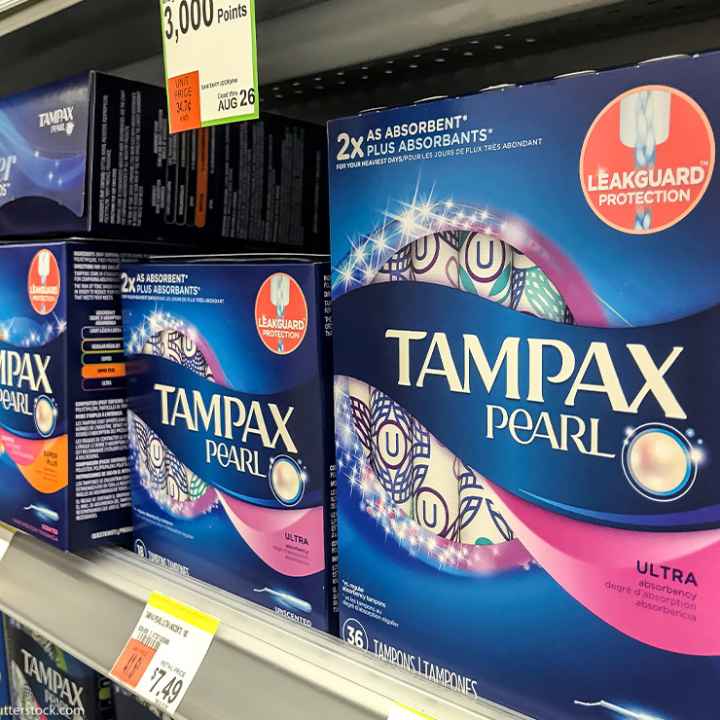 Tampax tampon boxes on the shelf in a pharmacy.