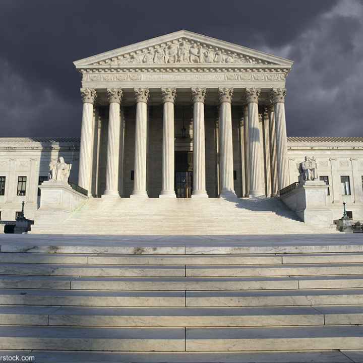 The Supreme Court beneath a cloudy sky.